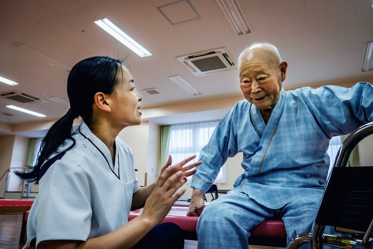 Old man in the hospital with a health worker