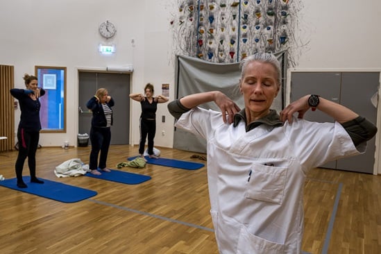 A yoga instructor leading a yoga class for cognitive rehabilitation