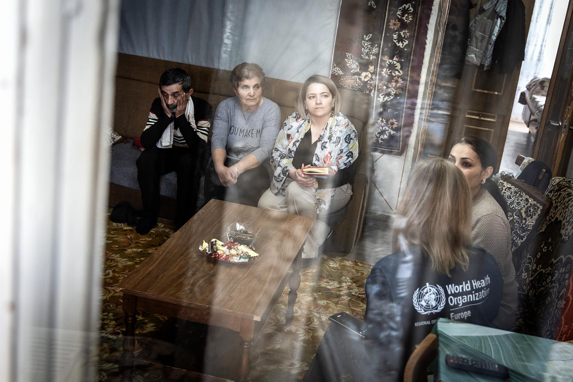 Zara Petrosyan, a social worker from the Karabakh region, meets with a refugee family.