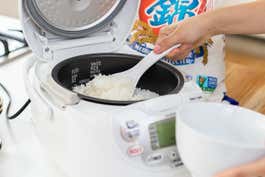 Scooping rice our of the Zojirushi rice cooker into a bowl