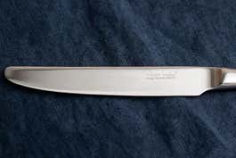 A look at the designer's signature on a table knife.