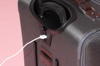 Close-up of a USB-A cable connected to the port on the back of the Travelpro Platinum Elite suitcase.