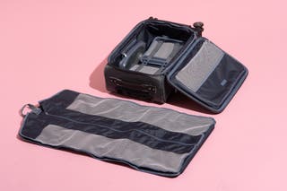 An opened Platinum Elite Carry-On Spinner next to its removable garment bag.