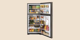 A black refrigerator propped open, displaying shelves full of perishable groceries.