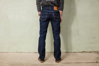A rear view of the tester modeling the darker wash Levi's jeans.