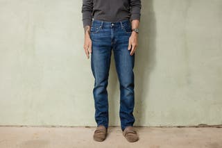 A tester modeling our pick for best affordable men's jeans that come in many sizes, the Uniqlo Men Slim-Fit Jeans.