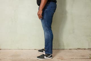 A side view of a tester modeling the Bonobos jeans for men.