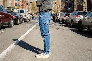 A side view of a tester modeling the lighter wash Bonobos men's jeans.