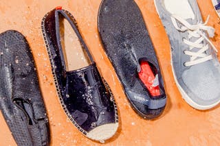 Four of our picks for the best water shoe, lined up side by side and splattered with water.