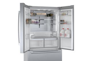 The Bosch B36CT80SNS french-door style refrigerator, shown in stainless steel with its top doors open.