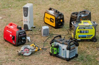 Space heaters, tools, and vacuums plugged into portable generators all sitting on a yellowing grassy lawn