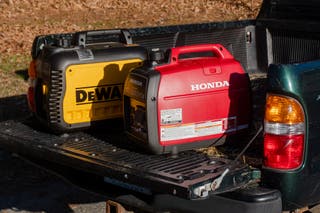 Dewalt and Honda portable generators in the bed of an open pickup truck
