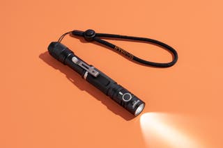 The Manker E12, our flashlight runner-up pick, with its light shining.