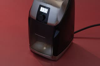 A Virtuoso Plus coffee grinder with the light in the bottom canister turned on.