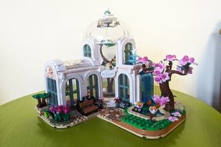 A completed Lego Friends Botanical Garden 41757 set on a green table with a white backdrop 