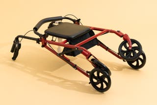 The Drive Durable Four Wheel Rollator, in its collapsed, folded-up position.