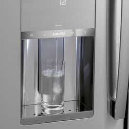 A glass being filled with water by the GE Profile PVD28BYNFS french-door refrigerators water dispenser.