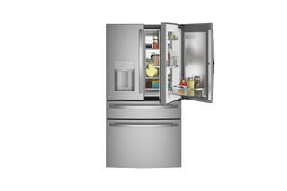 A stocked GE Profile PVD28BYNFS french-door refrigerator, with one of its top doors open, revealing its door-in-door organizational feature.