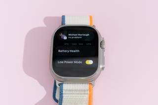 The Apple Watch Ultra 2 showing the Battery Health screen with Low Power mode on, and a text notification at the top of the screen.