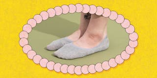A person's foot wearing a gray pair of the Eedor Women’s Non Slip Low Cut Socks.