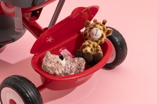 The Radio Flyer 4-in-1 Stroll ’N Trike’s basket with two stuffed animals in it.