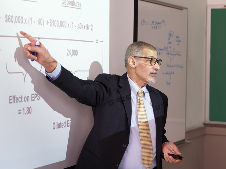 Accounting professor gives class lecture. 