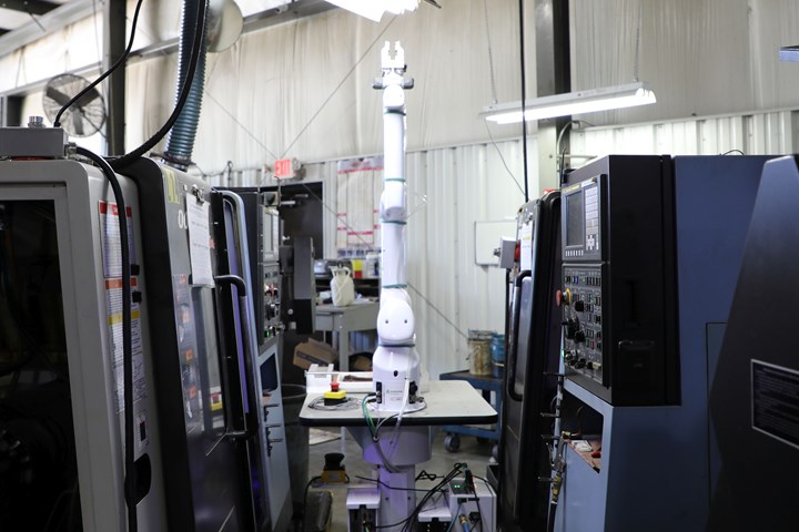 OB7 cobot arm installed between two Doosan turning machines