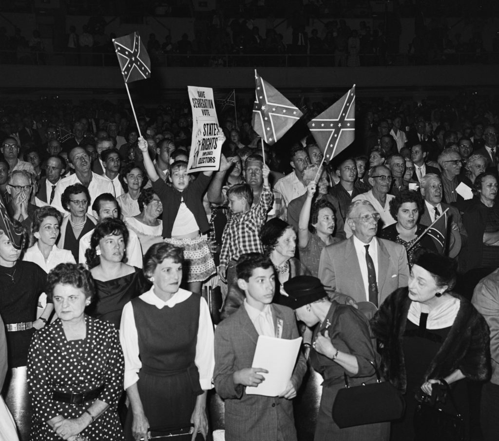 Young children wave Confederate flags at a White Citizens’ Council meeting in New Orleans, Louisiana, on November 16, 1960