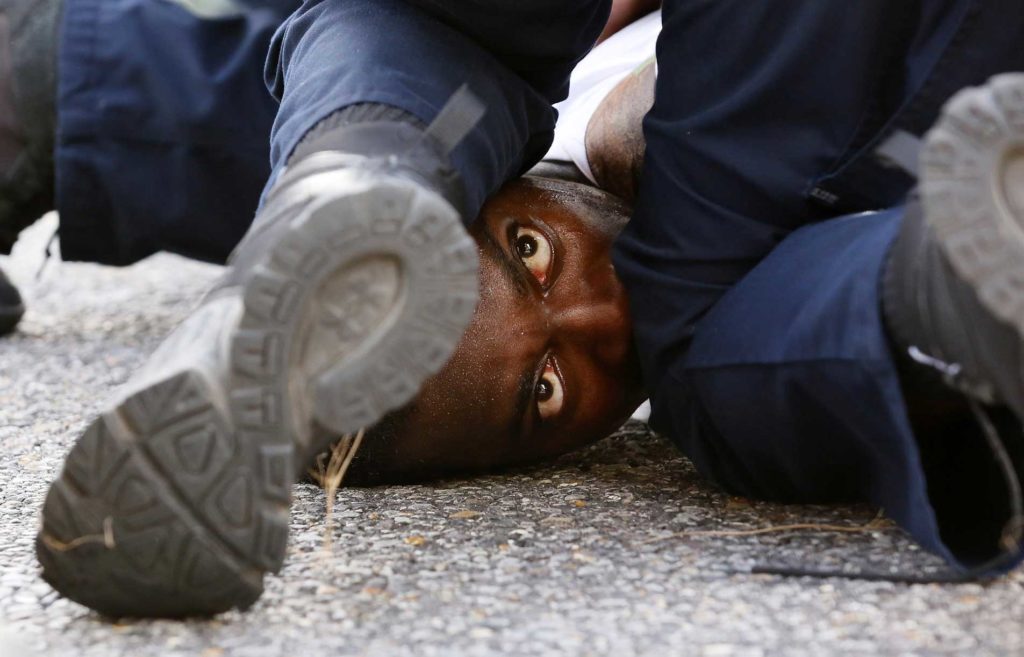 A man is wrestled to the ground by law enforcement in Baton Rouge, Louisiana, while protesting the July 2016 shooting death of Alton Sterling.