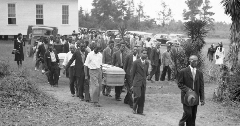 Mourners carry flag-draped coffin of veteran George Dorsey, who was lynched in 1946