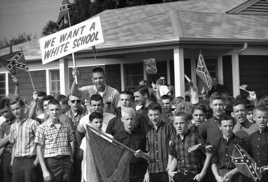 Teenage boys wave Confederate flags during a protest against school integration in Montgomery, Alabama, 1963