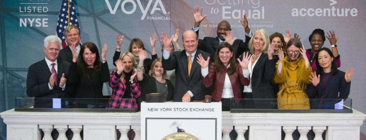 A large group of people celebrate the VOYA Financial's launch on the New York Stock Exchange.