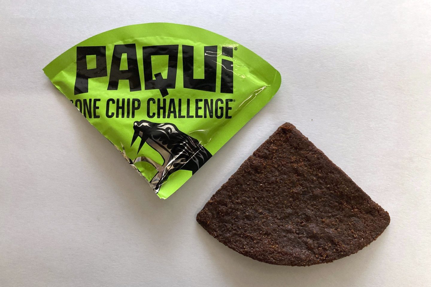 FILE &#8211; A Paqui One Chip Challenge chip is displayed in Boston, Friday, Sept. 8, 2023.  A medical examiner says a Massachusetts teen who participated in a spicy tortilla chip challenge died from ingesting a substance “with a high capsaicin concentration,” according to autopsy results The Associated Press obtained late Wednesday, May 15, 2024. Capsaicin is a chili pepper extract. Harris Wolobah died on Sept. 1, 2023, after eating the chip. (AP Photo/Steve LeBlanc, File)