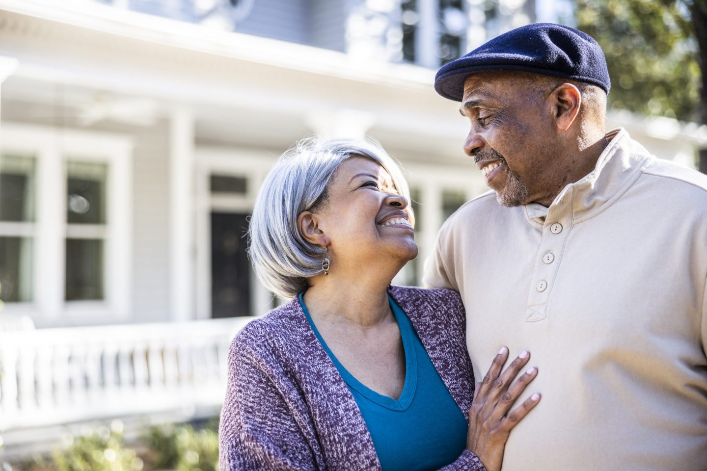Portrait of senior couple in front of suburban home