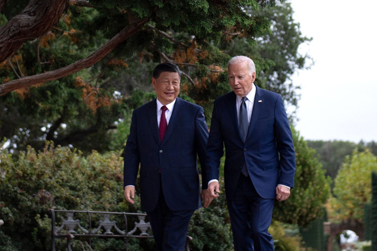 President Joe Biden walking alongside President Xi Jinping of China.