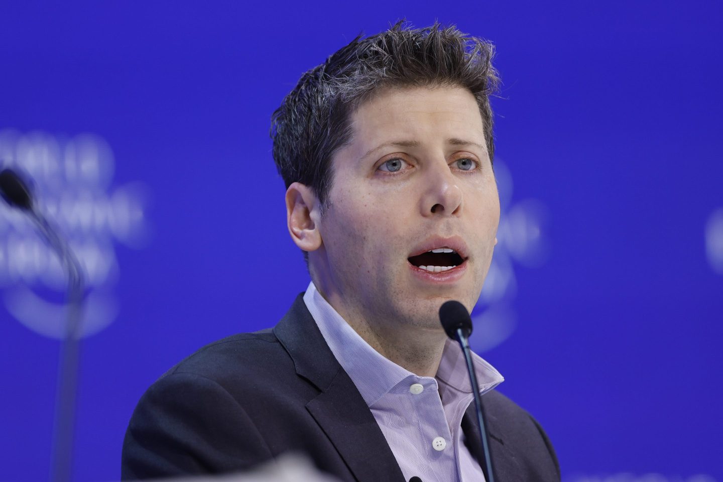 Sam Altman, chief executive officer of OpenAI, speaks into a microphone.
