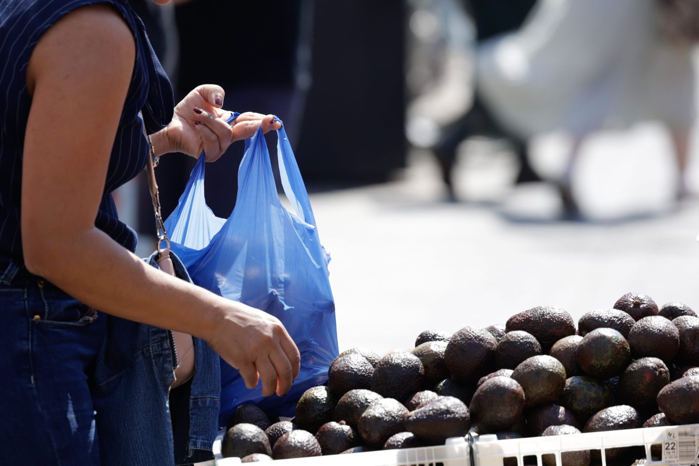 Woman shops for avocados