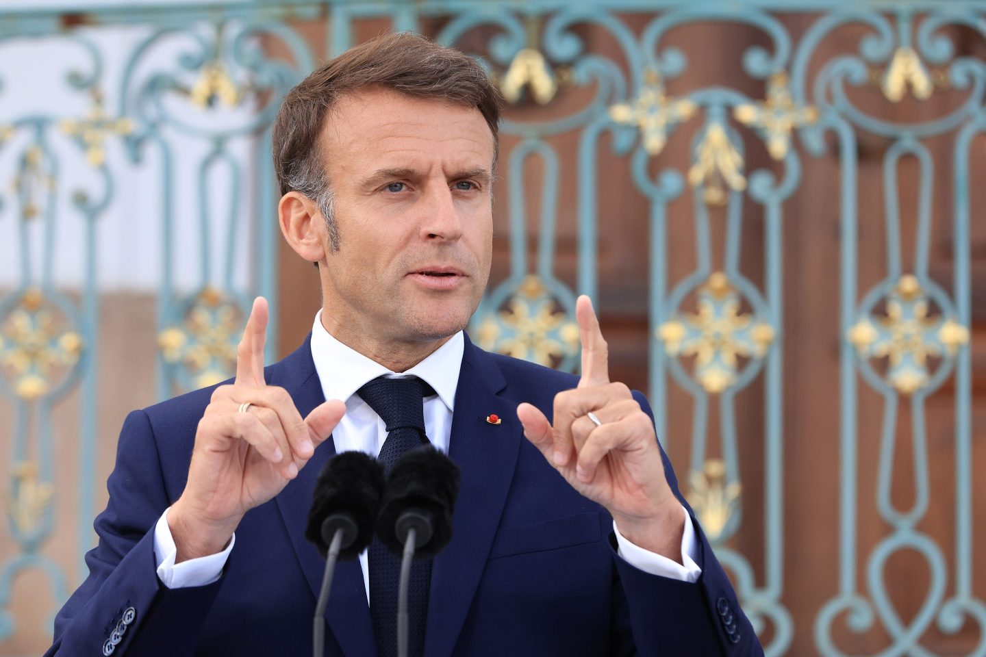 Emmanuel Macron gestures with hands while speaking
