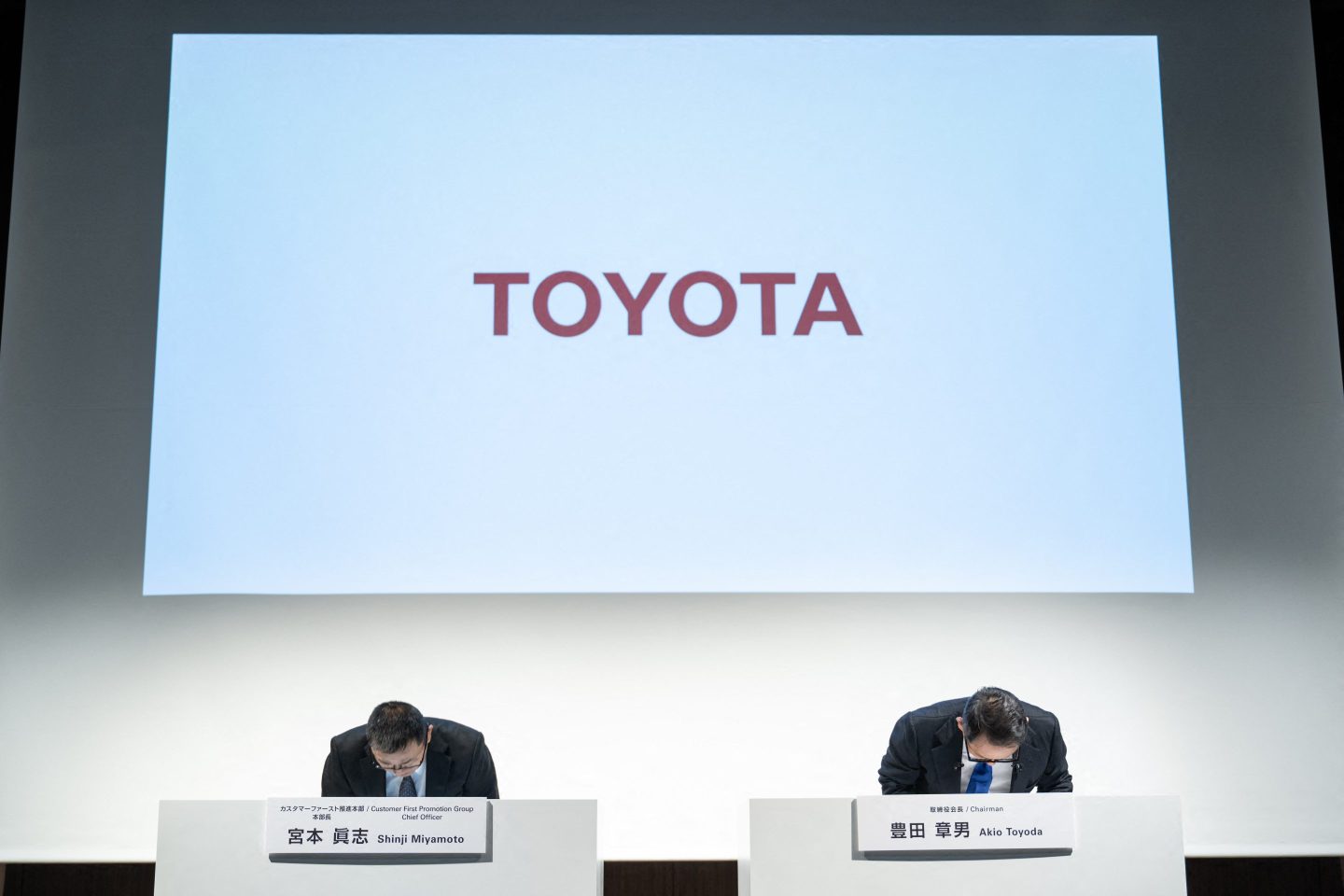 Toyota Motor Chairman Akio Toyoda (R) and Customer First Promotion Group Chief Officer Shinji Miyamoto (L) bow during a press conference in Tokyo on June 3, 2024. Toyota said it had suspended domestic shipments of three car models after falling foul of government certification rules.