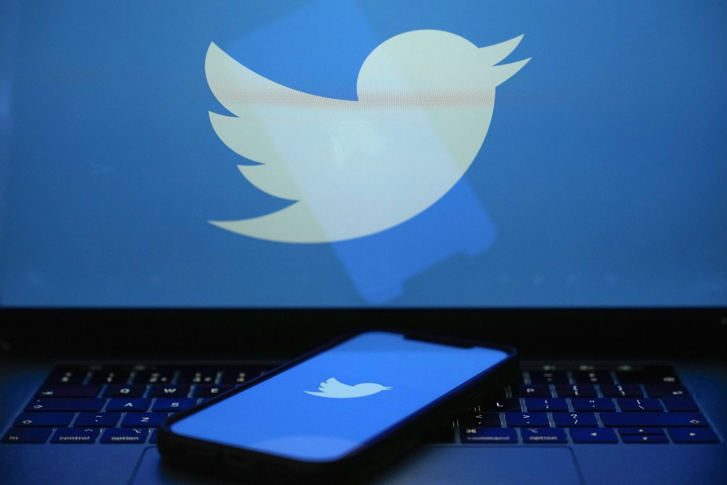 KNUTSFORD, UNITED KINGDOM APRIL 21: In this photo illustration the Twitter logo is seen on a computer screen and mobile cellphone on April 21, 2023 in Knutsford, United Kingdom. The social media company started removing large numbers of the blue verification check marks, or &#8220;blue ticks,&#8221; that had historically indicated a verified account. The company said in a statement that they are &#8220;removing legacy verified checkmarks&#8221; and, to remain verified on Twitter, users can sign up for the paid Twitter Blue subscription. (Photo illustration by Christopher Furlong/Getty Images)
