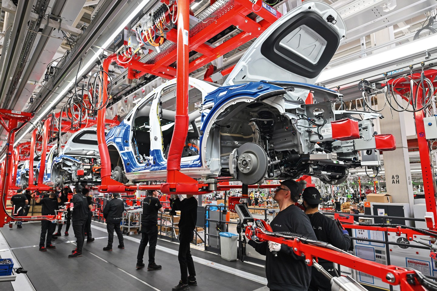 Workers assemble electric vehicles at Tesla’s Giga Berlin complex in Grünheide, Germany. The factory and its 11,000 workers are on track to produce 250,000 Model Y SUVs in 2023.