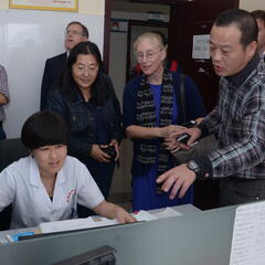 Karen Eggleston visiting a health clinic in China 