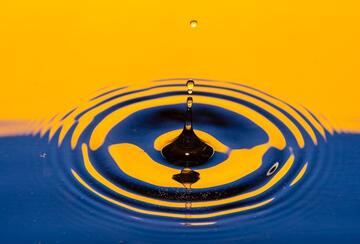 water rippling from a drop of water shaded blue and yellow