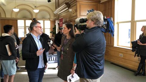 Colin Kahl speaks with a television reporter in Encina Hall following an event on US-Iran relations in January 2020.