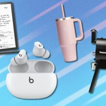 an amazon kindle scribe, a pair of white beats studio earbuds, a pink hydro flash water bottle with pink straw, and a black traeger barbecue all sit on a light blue background that has lighter blue streaks running though it diagonally 