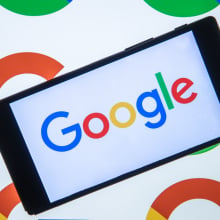  the logo of Google is displayed on the mobile phone screen in front of the logo of Google displaying on the screen