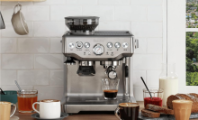 breville espresso machine on top of a wooden counter