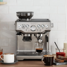 breville espresso machine on top of a wooden counter