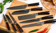 Knife set displayed on cutting board.
