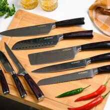 Knife set displayed on cutting board.